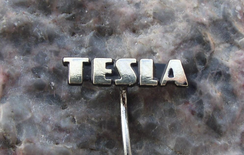 Antique Tesla Electronics Firm Capital Letter Logo Equipment Black Pin Badge
