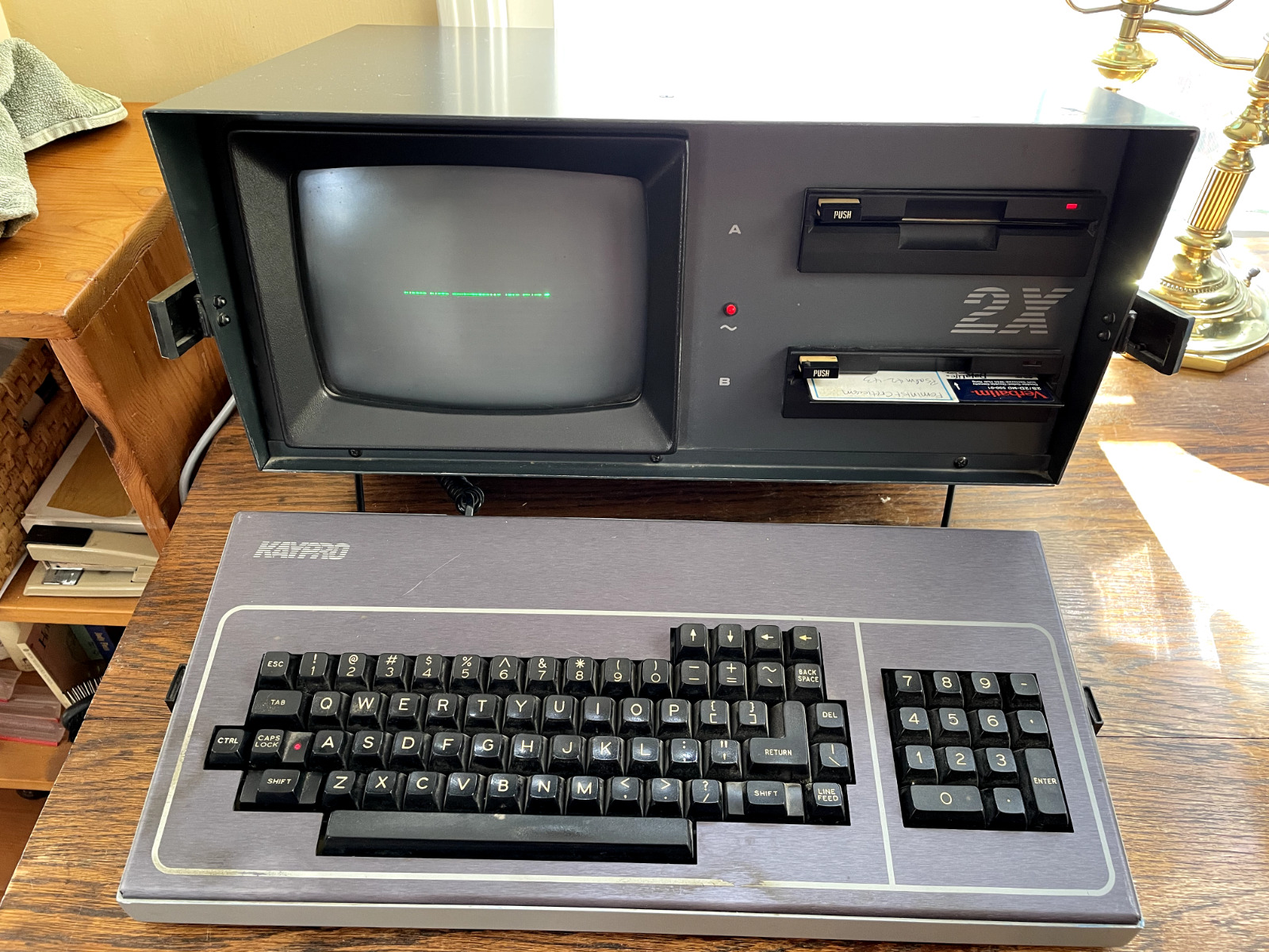 Vintage Kaypro 2X luggable computer with disks and carrying case