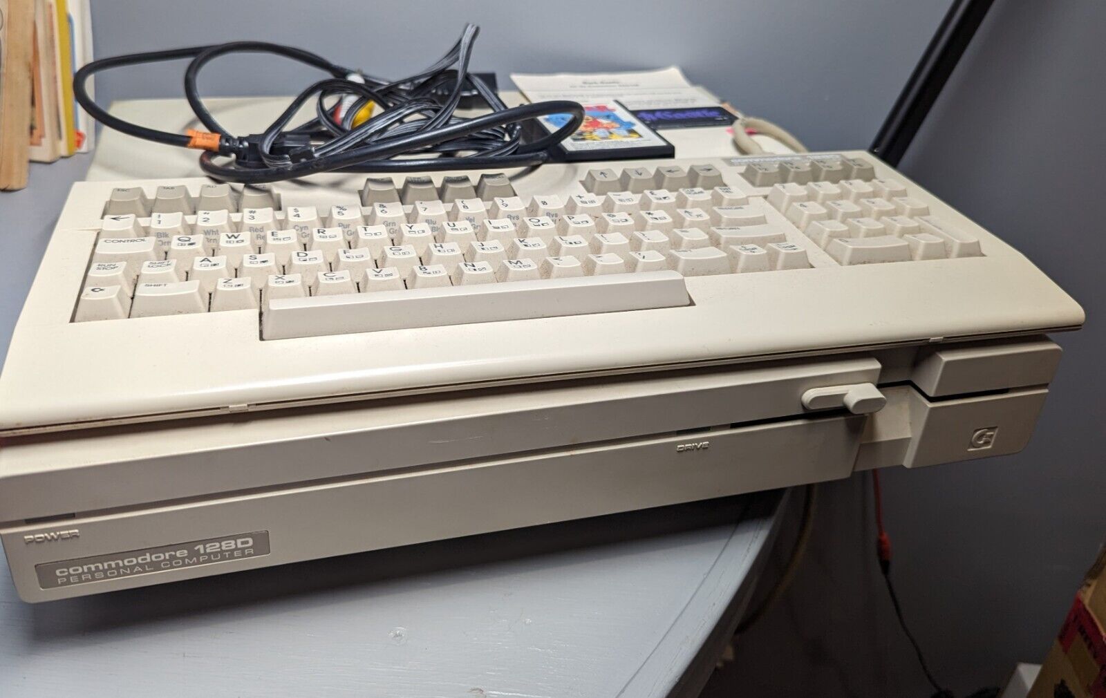 vintage Commodore 128d computer with keyboard, cords and game