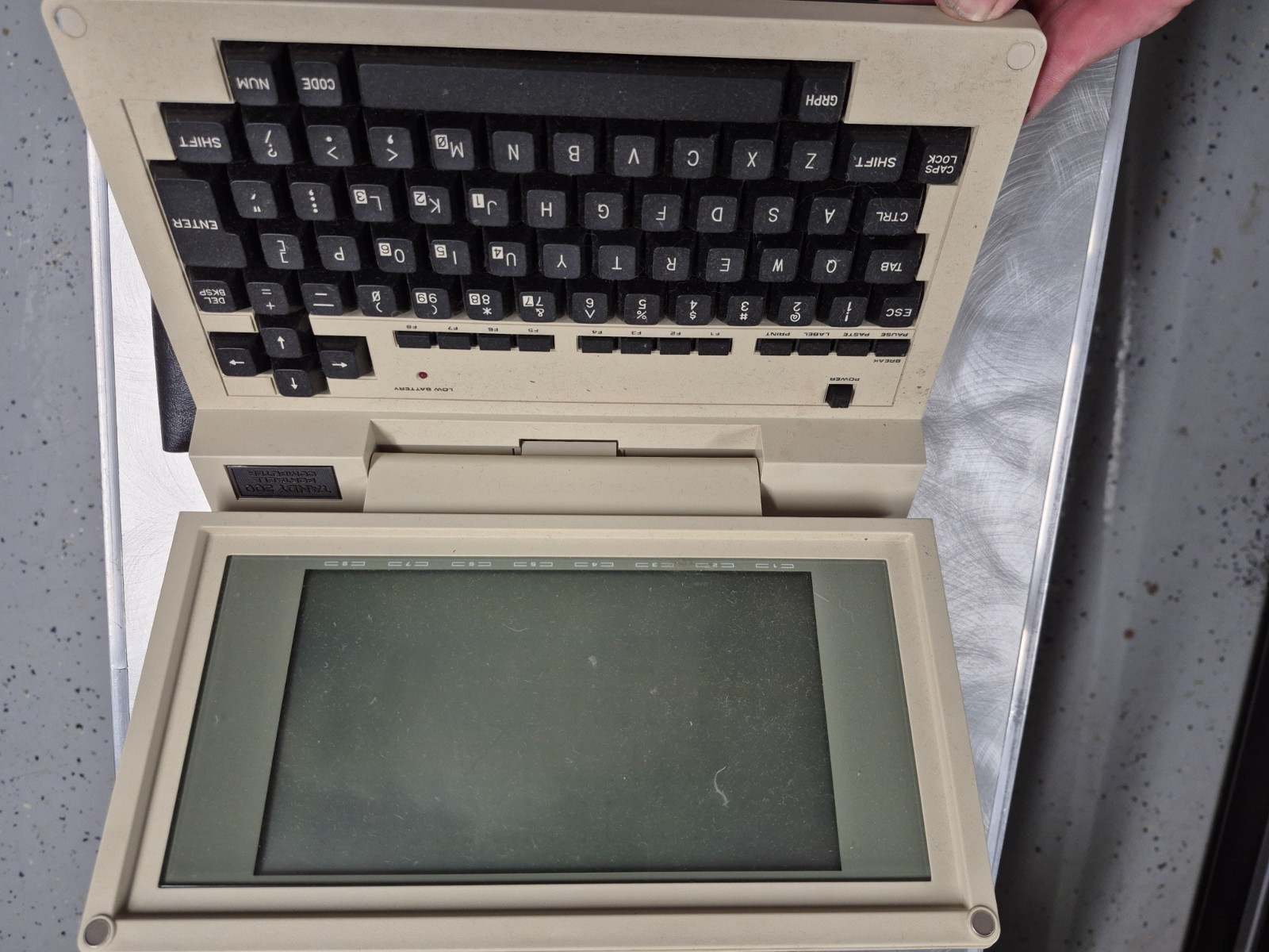 Vintage Tandy 200 Portable Computer with plastic travel sleeve, no power supply