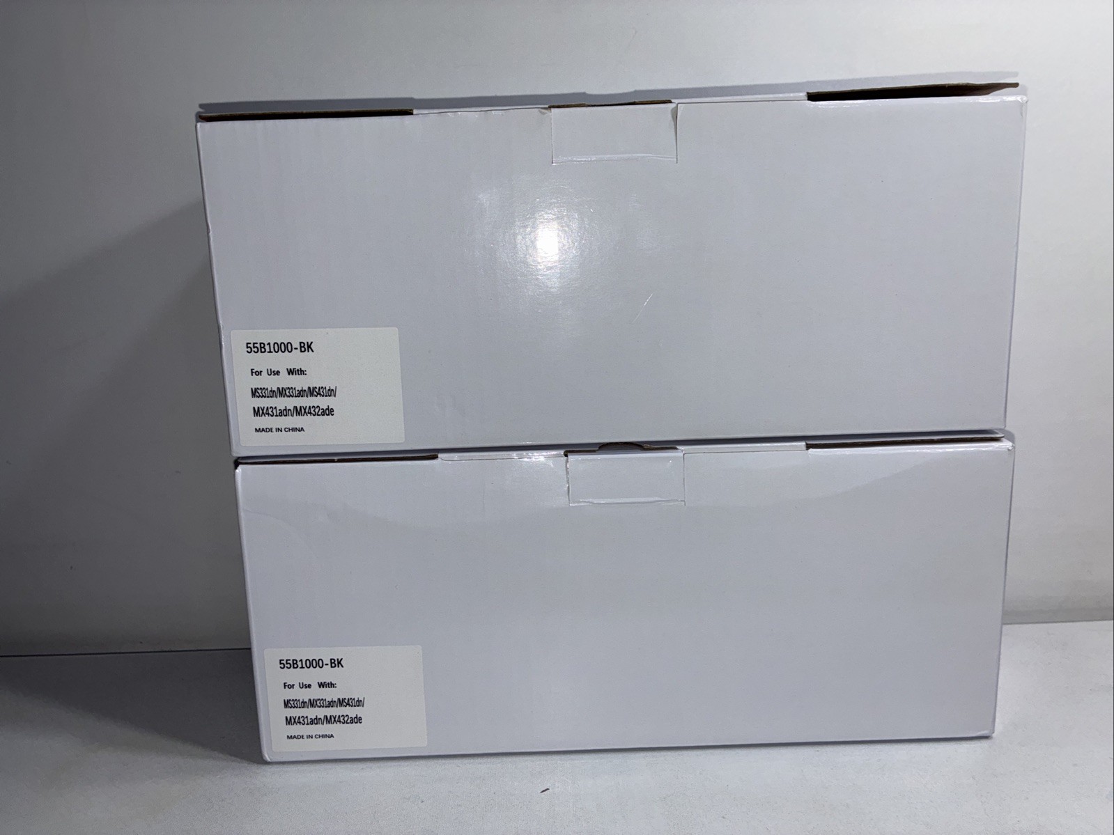 2 - Reconditioned 55B1000 Toner Cartridge Replacements, One Open