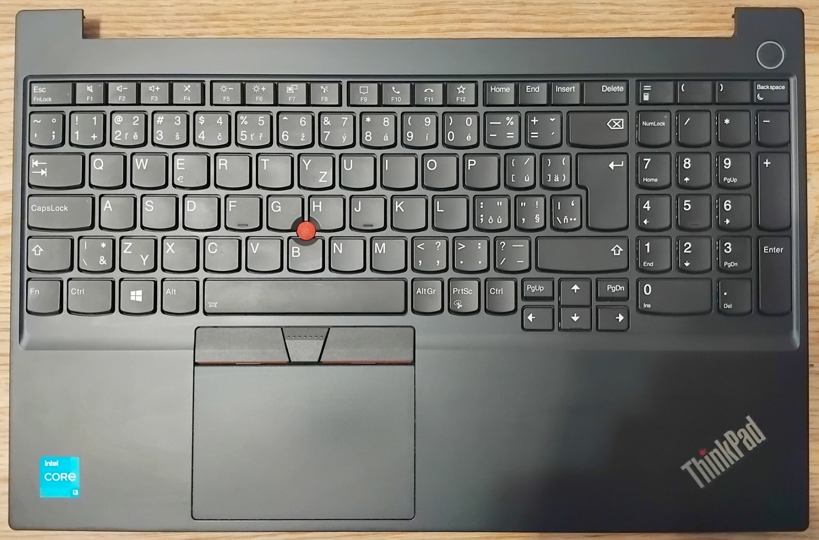 Laptop keyboard complete with palmrest, touchpad and power button.