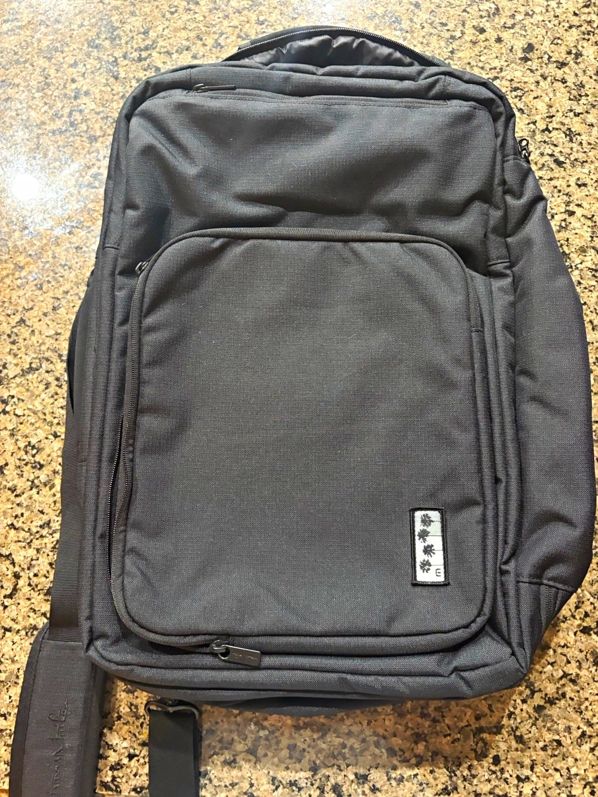 TravisMathew 1st class Lateral convertible Laptop  backpack. palm tree logo