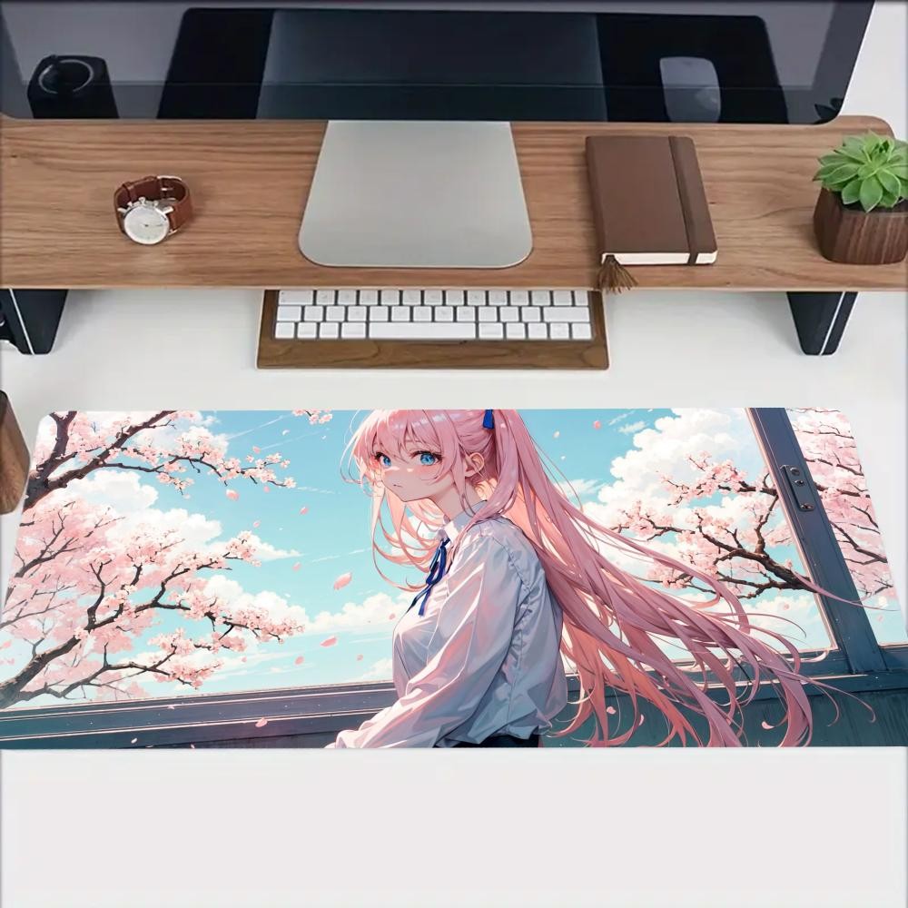 A Large Rubber Mouse Pad Featuring a Pink Cherry Blossom Design, Perfect for D