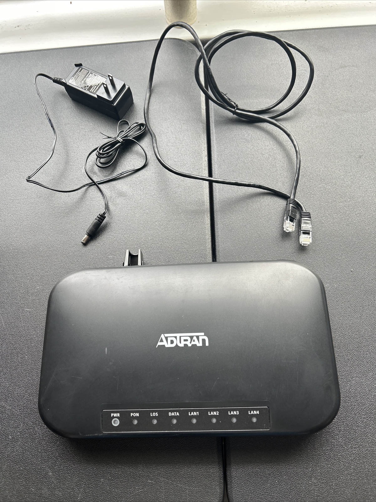L) ADTRAN Model #1004 176100430F1 With 2 Cables Pictured