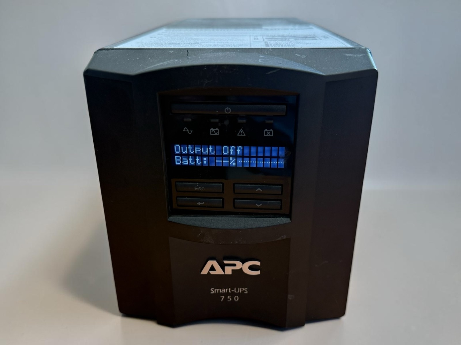 Pre-owned APC Smart-UPS 750, model SMT750. Unit powers on and LCD display is wor