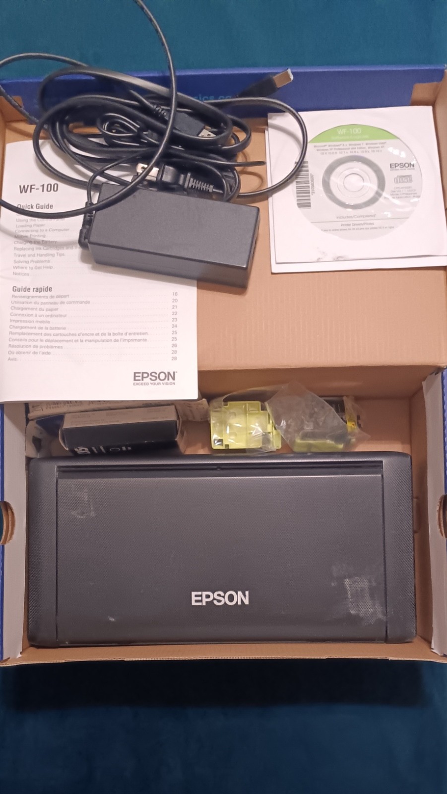 Epson WF-100 Portable Wireless Printer includes: Ink, Manual, Power Cord and CD