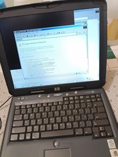 HP laptop, with Windows XP, DVD slot built in on side. Its picture