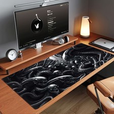 A Large Gaming Mouse Pad Featuring a Dark, Alien Skull Entwined with Mechanica picture